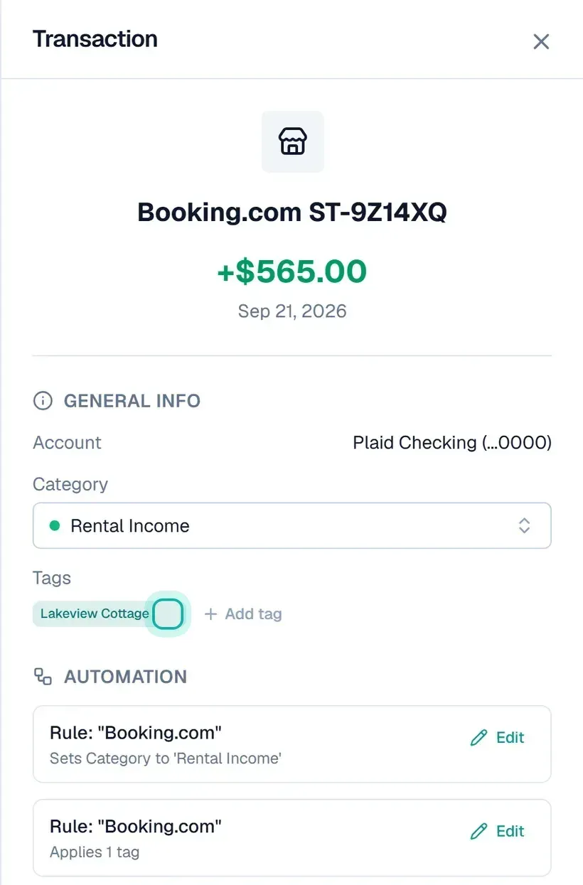 A Booking.com payout of +$565.00 from Sep 21, 2026, open in its detail panel. It landed in a checking account, is filed as Rental Income, and has the Lakeview Cottage tag, highlighted, just applied. Under Automation, two rules on "Booking.com" are listed, one setting the category to Rental Income and one applying a tag.